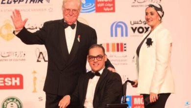 لافتة إنسانية لـ حسين فهمي على السجادة الحمراء لمهرجان القاهرة السينمائي 45