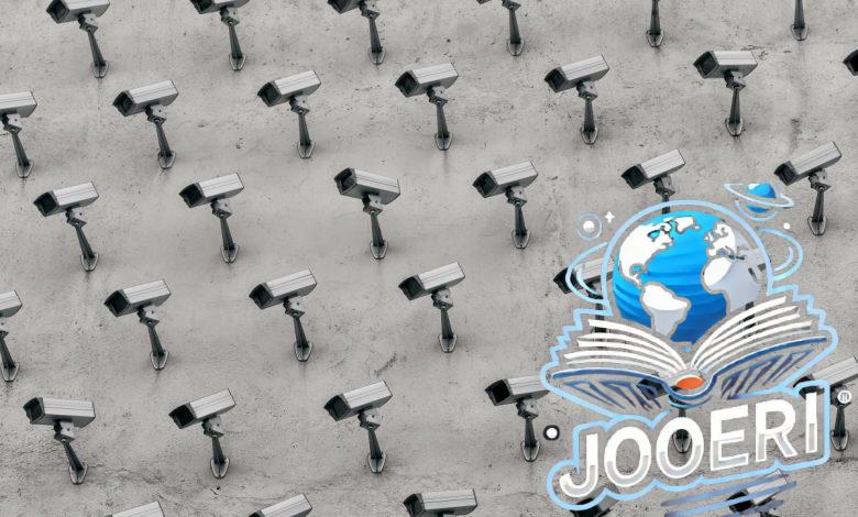a pattern of CCTV surveillance cameras on a wall, all pointing in different directions.