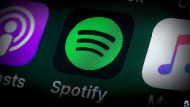 The buttons of the music streaming app Spotify, surrounded by Podcasts, Apple Music, Facebook and other apps on the screen of an iPhone.